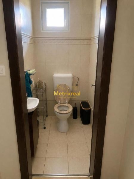 Bathroom in a family house with a toilet and a sink.