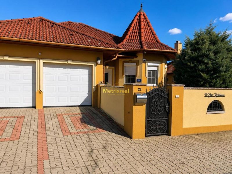 A family house in Darnózseli with a terracotta roof and a double garage.