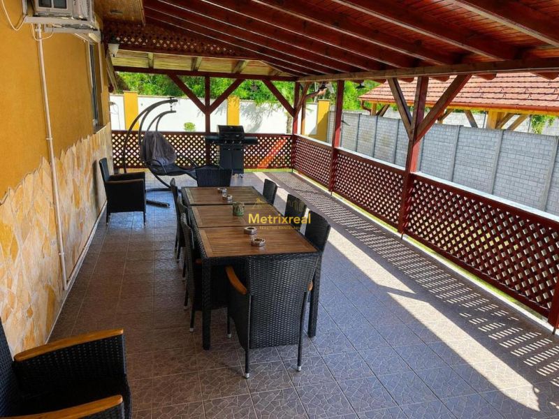 A terrace of a family house in Darnózseli with a grill and comfortable seating.