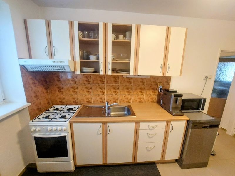 A kitchen with a kitchenette and appliances in a 2-room apartment.