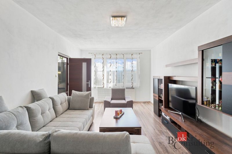 Kitchen and living room in a 2-room apartment with a wooden decor floor.