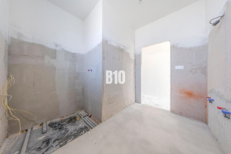 Unfinished space with concrete walls, with installation outlets in a family house.