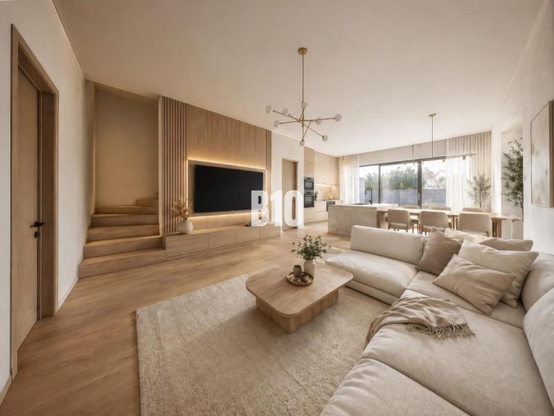 Living room of a family house with a wooden decor floor, light furniture, and large windows.