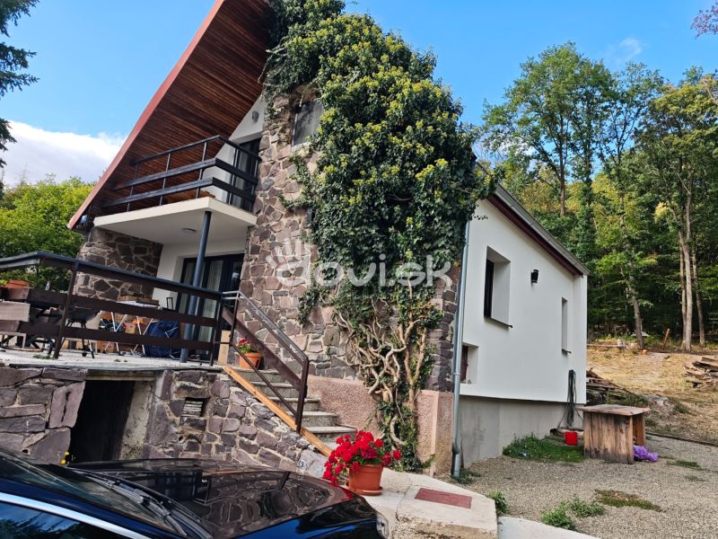 A cottage on Kamenec in Kaluža with a stone facade and a terrace surrounded by greenery.