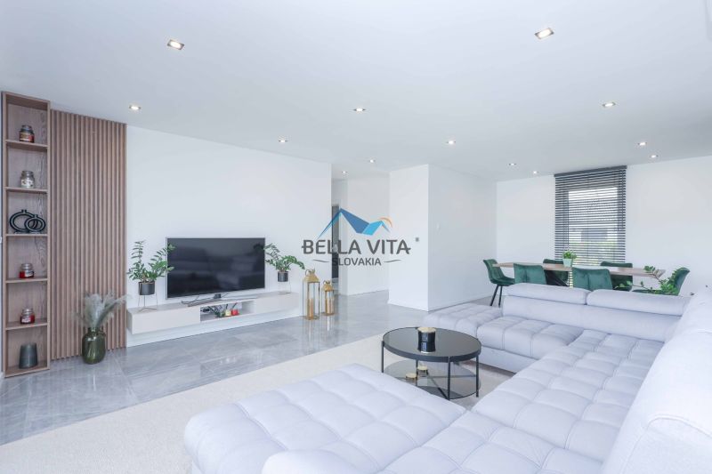 Living room in a family house with a couch, television, and decorative elements.