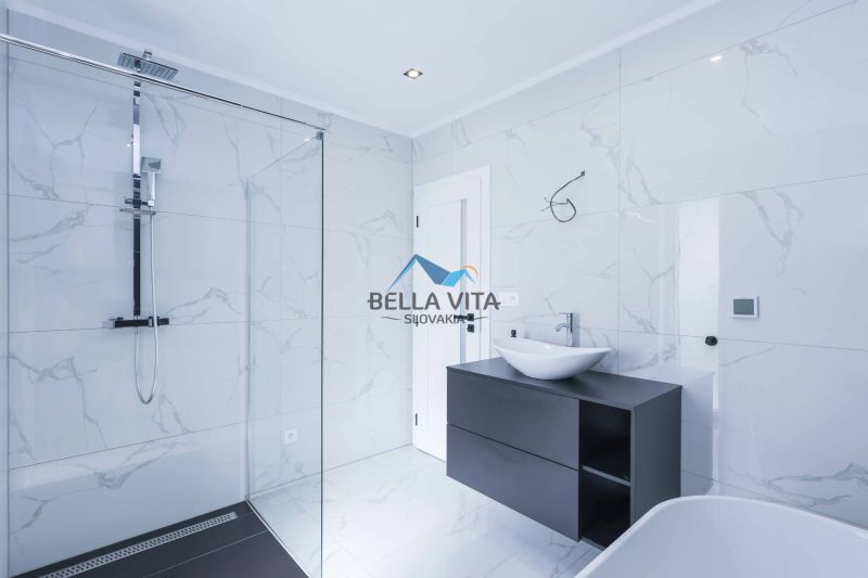 Bathroom in a family house with an elegant shower and sink.