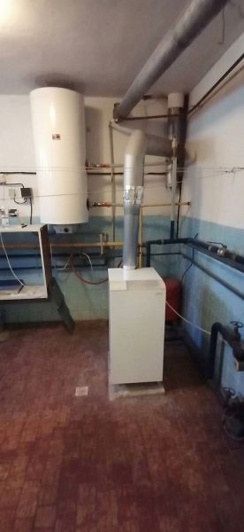 Heating and boiler in a family house with a wooden decor floor.