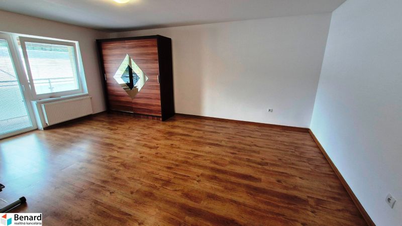 A room with a wooden floor decor and a wardrobe in a 3-room apartment.