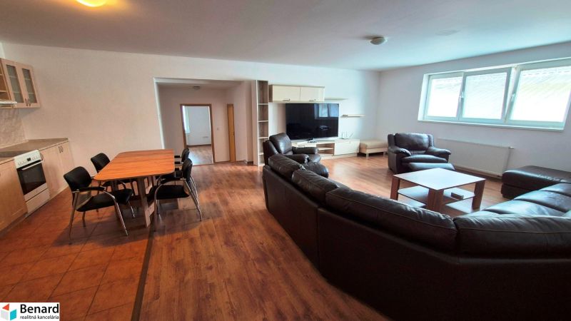 Living room in a three-room apartment with comfortable leather sofas and a floor with a wooden decor.