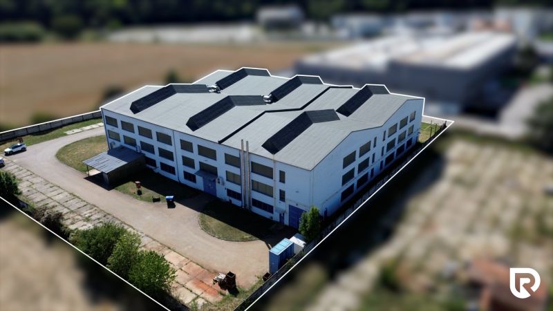 White building in the complex of warehouses and halls on K výstavisku street in Trenčín.