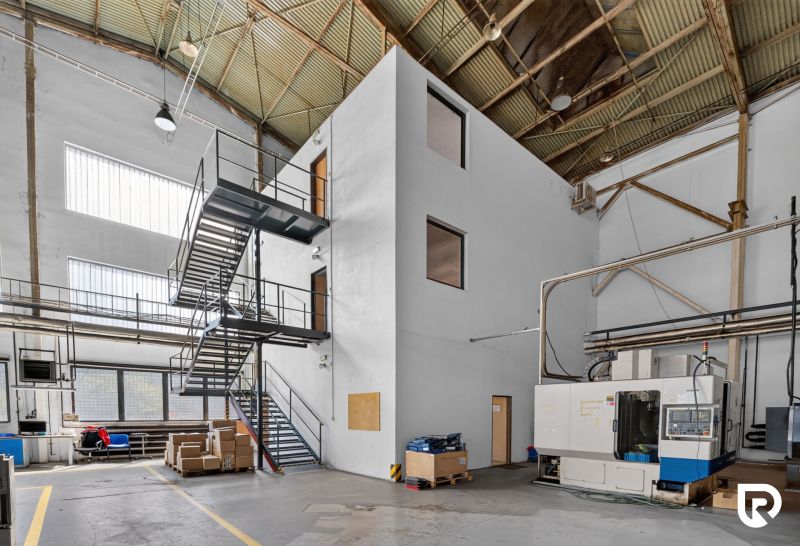 Interiors of warehouses and halls with industrial stairs and machinery, without wooden decor.
