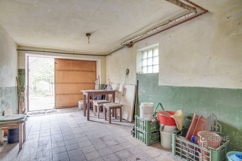 Garage in a family house with a workbench and stored items.