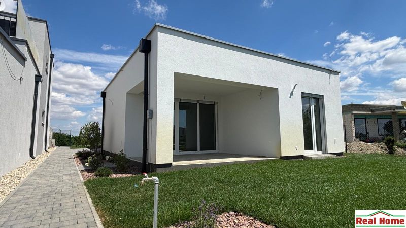 A family house in Boldog with a well-maintained garden, paved walkway, and spacious terrace.
