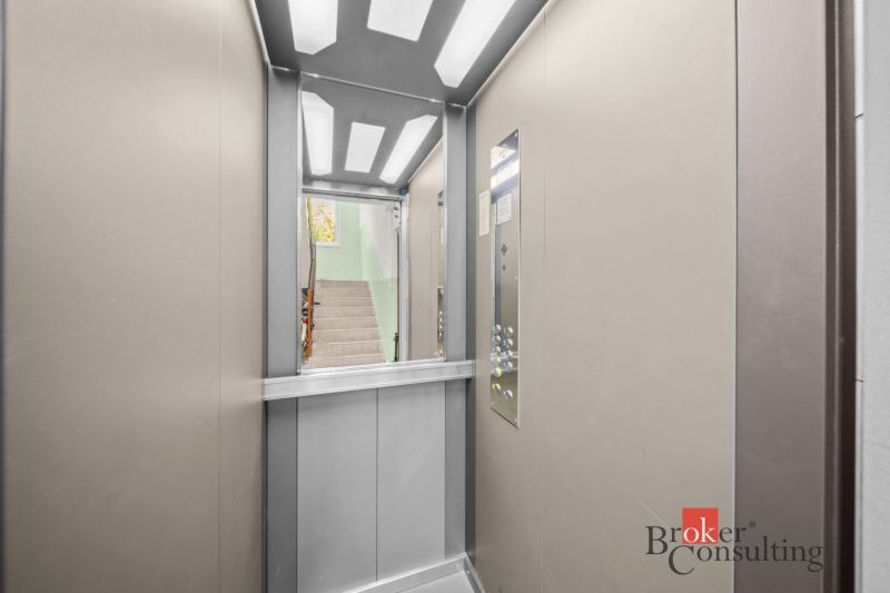 Elevator in a 3-room apartment with a view of the staircase.