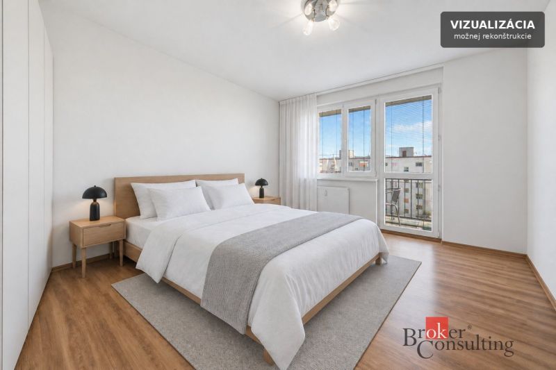 A bright bedroom with a bed and wood-decor flooring in a 3-room apartment.