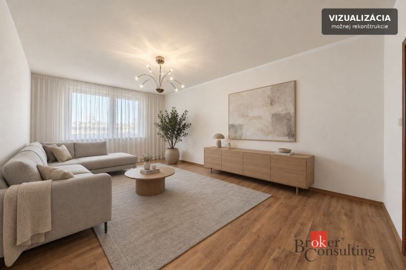 Living room in a 3-room apartment with a wooden decor floor, beige sofa, simple decorations.
