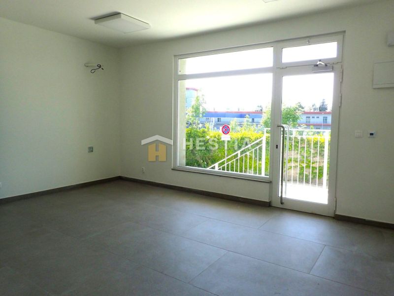 Spacious interior with a large window, suitable for commercial land.