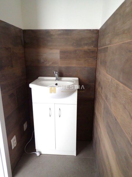 A sink in a bathroom with wooden decor walls, Plots - commercial.