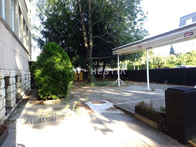 Outdoor terrace in commercial premises in Senica surrounded by trees and greenery.