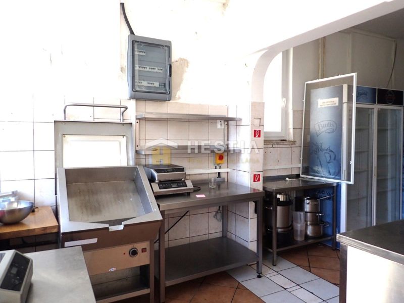 Kitchen equipment in commercial premises with a wooden decor floor.