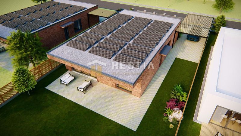 A family house in Hlboké with a terrace, lawn, and solar panels on the roof.