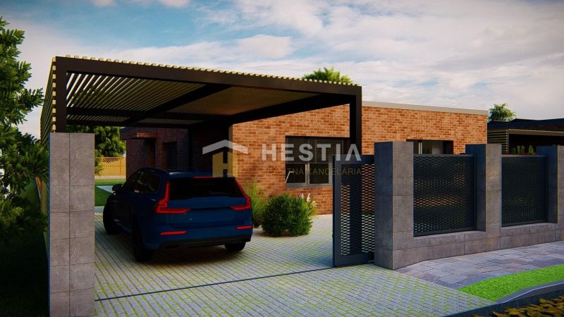 A family house in Hlboké with a brick facade and a carport.
