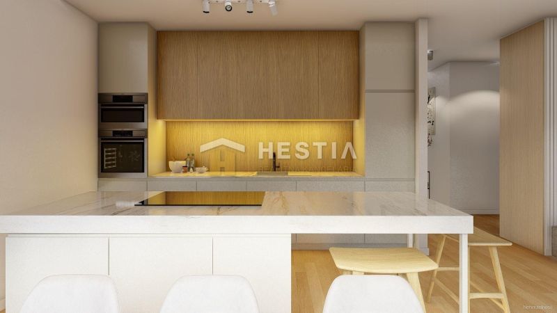 A kitchen in a family house with a wooden decor floor and built-in appliances.