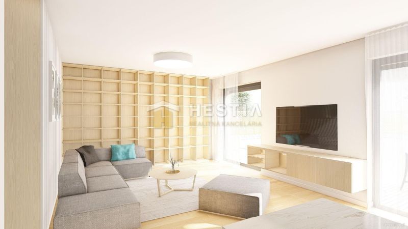 Living room with wood-patterned flooring, gray sofa, and shelves in a family house.