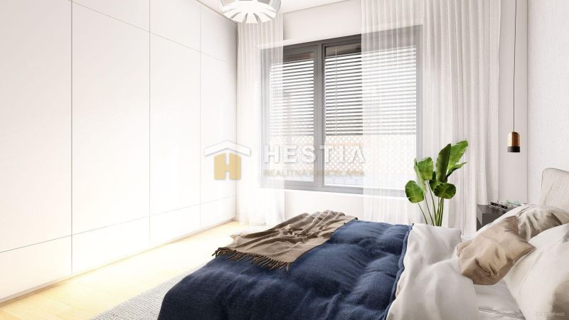 A bedroom in a family house with a delicate curtain, a large window, and a plant.