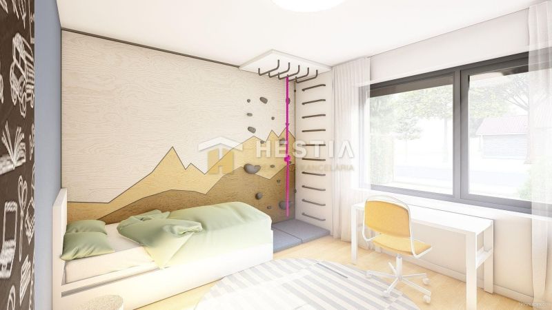 Children's room with a climbing wall and furniture in a family house on a floor with a wooden decor.