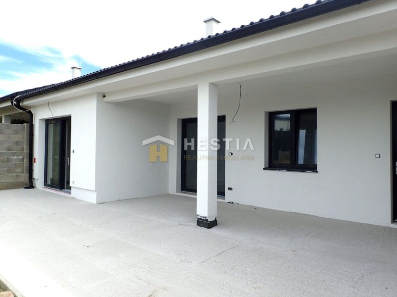 A family house in Hlboké with a light facade and a spacious terrace.