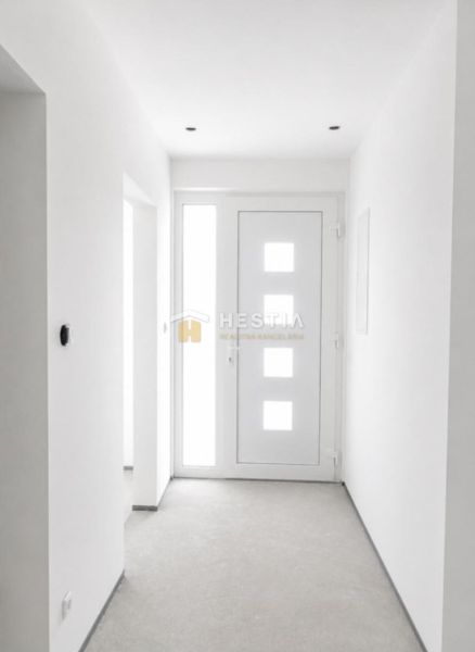 Interior with white walls and light doors in a family house.