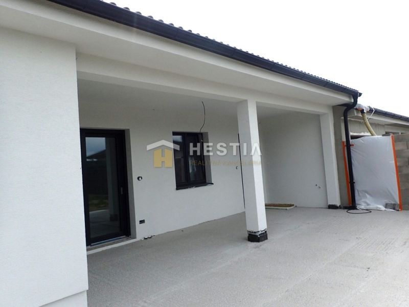 A family house in Hlboké with an open terrace and a white facade.