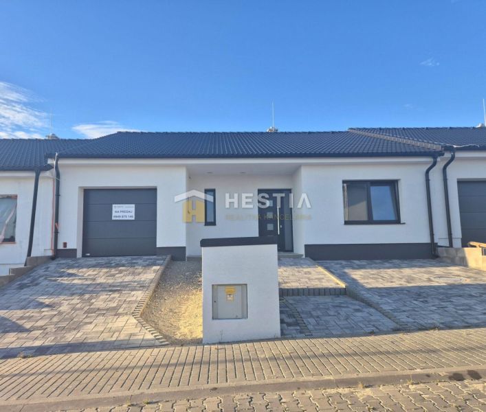 A family house in Hlboké, a single-story building with a garage and a paved driveway.