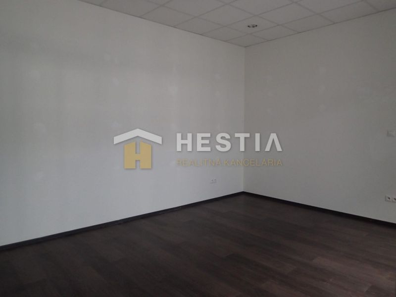 An empty room with a wooden decor floor in a 2-room apartment.