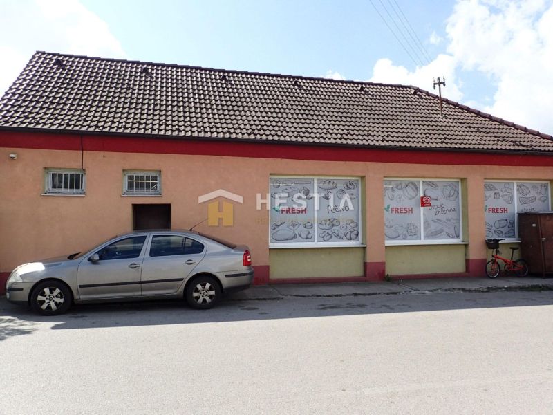 The family house in Borský Mikuláš has a brick facade, with a car parked next to it.