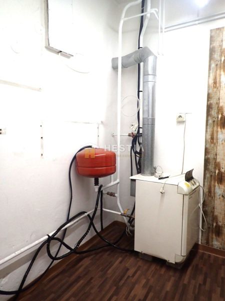 Heating and plumbing in a family house, floor with wooden decor.