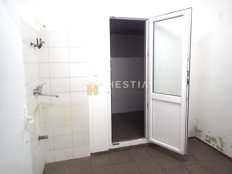The interior of a family house with white walls, doors, and bathroom tiles.