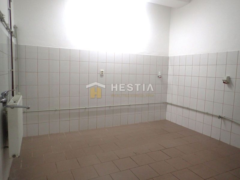 Room with white tiles and a radiator in a family house.