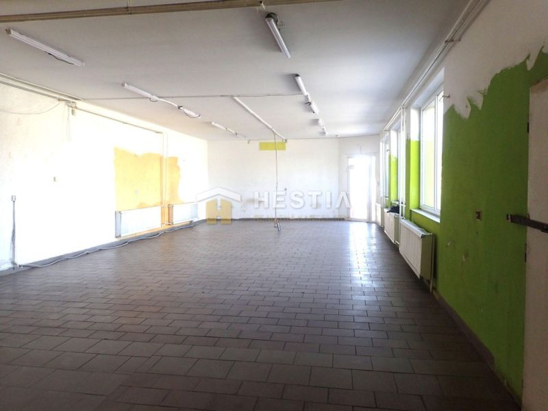 A spacious room with tiles and colorful walls in a family house.