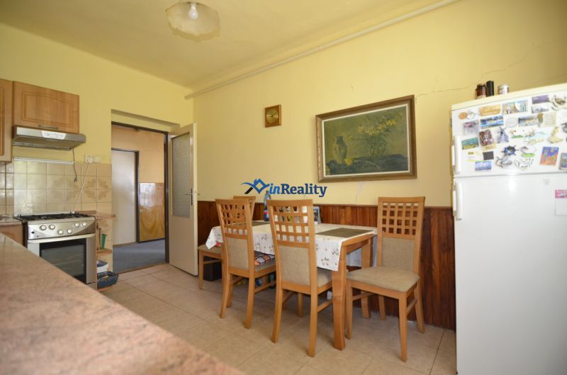 Dining room with wooden chairs and a table in a family house.