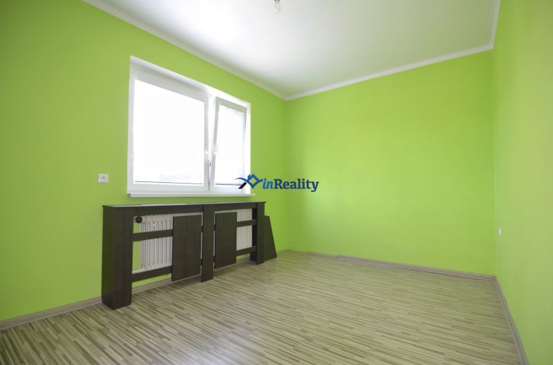 Bright room with wood-patterned flooring in a family house.