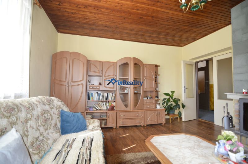 Living room with wooden decor furniture, wooden decor flooring, sofa.