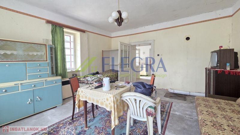 Living room in a family house with retro furniture, table and chairs, television.