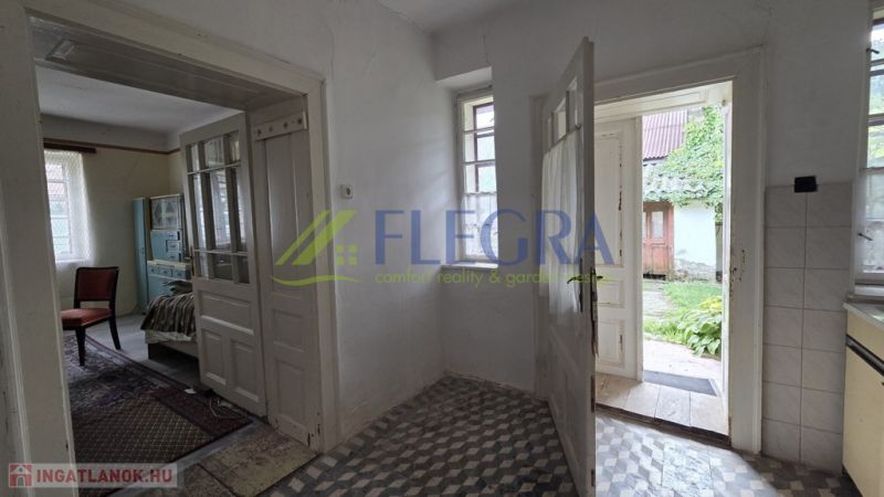 In a family house with a wooden decor floor, a view of the garden opens up.