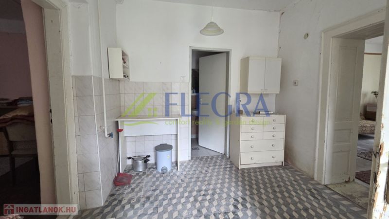 The interior of a family house with tiles and white furniture.