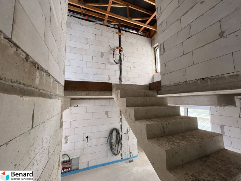 Interior with concrete stairs and raw walls in commercial premises.