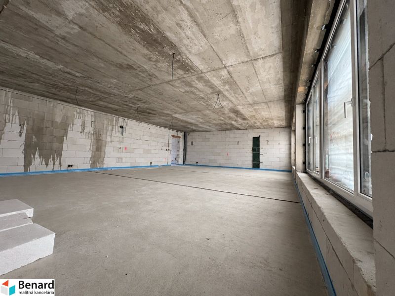 Commercial spaces with concrete walls, large windows, and white bricks on the floor.