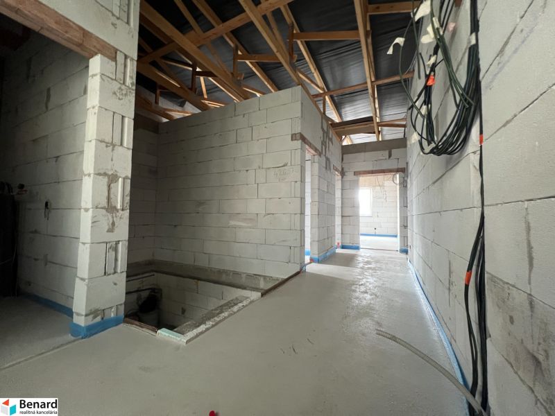 Interior of commercial premises with concrete flooring and electrical installations.