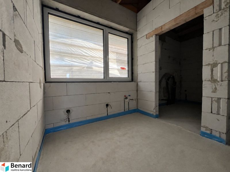 Interior with unfinished walls, a window, and preparations for electrical installations in commercial spaces.